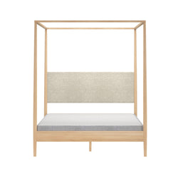 Modern light wood canopy bed frame with beige upholstered headboard and low-profile mattress, minimalist four-poster platform bed