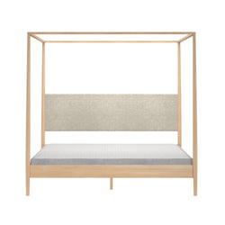 Minimalist four-poster canopy bed frame in light natural wood with gray upholstered headboard and platform mattress, modern bedroom furniture