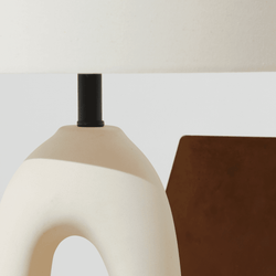 Modern ceramic table lamp close-up with beige shade and minimalist design.