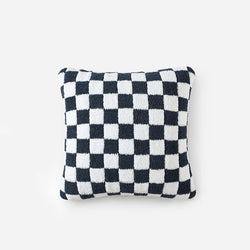 Black and white checkered decorative pillow on white background.