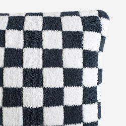 Checkered black and white textured pillow close-up.