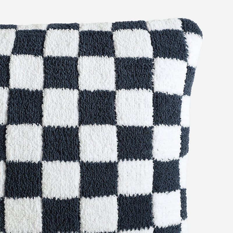 Checkered black and white textured pillow close-up.