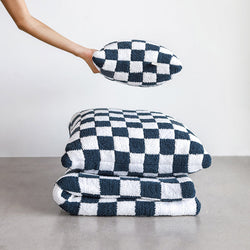 Checkered black and white throw pillows and blanket set, modern home decor.