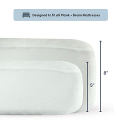 Two white Plank + Beam mattresses with dimensions labeled as 5 inches and 8 inches, designed to fit all Plank + Beam beds.