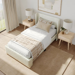 Contemporary bedroom with beige upholstered bed, wooden nightstands, modern lamps, and neutral decor.