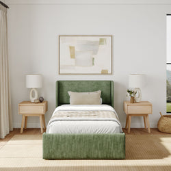 Modern minimalist bedroom with green upholstered bed, wooden nightstands, and abstract wall art.