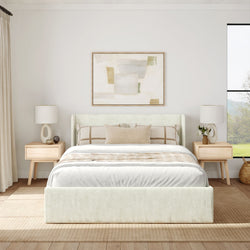 Modern bedroom interior with beige upholstered bed, neutral tones, and abstract wall art.