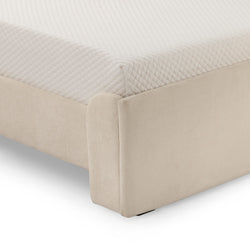 Cream upholstered bed with quilted mattress accentuating modern bedroom design.