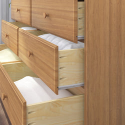 Wooden dresser with open drawers showcasing spacious storage for clothing and linens.