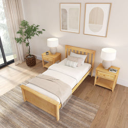 Minimalist neutral bedroom featuring a solid wood single bed, matching nightstands, beige bedding, modern lamps, and a potted plant