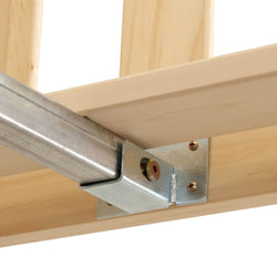 Close-up of a metal garage door track bracket bolted to a wooden header, showing galvanized rail, mounting plate and screws