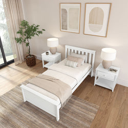 Modern minimalist neutral bedroom with white wooden single bed, matching nightstands and lamps, potted plant, abstract wall art, and hardwood floor