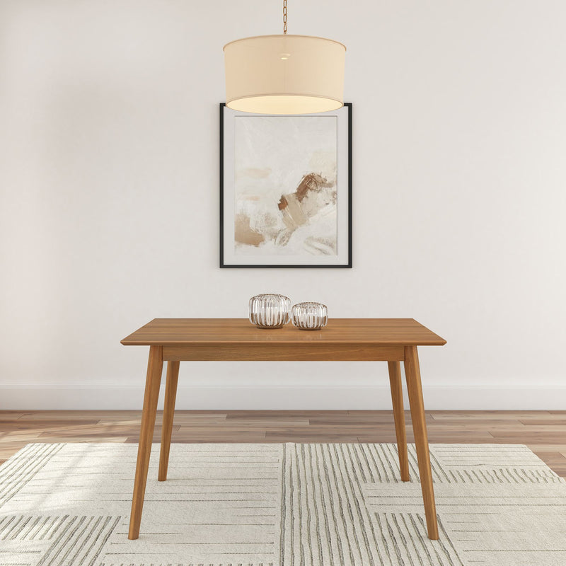 Modern wooden dining table with minimalist decor and abstract art on wall.