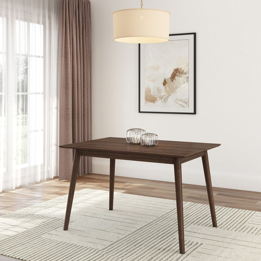 Modern dining room with wooden table, abstract wall art, and pendant light fixture.