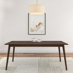 Modern living room with a sleek wooden dining table, glass candle holders, abstract wall art, and a stylish pendant light.
