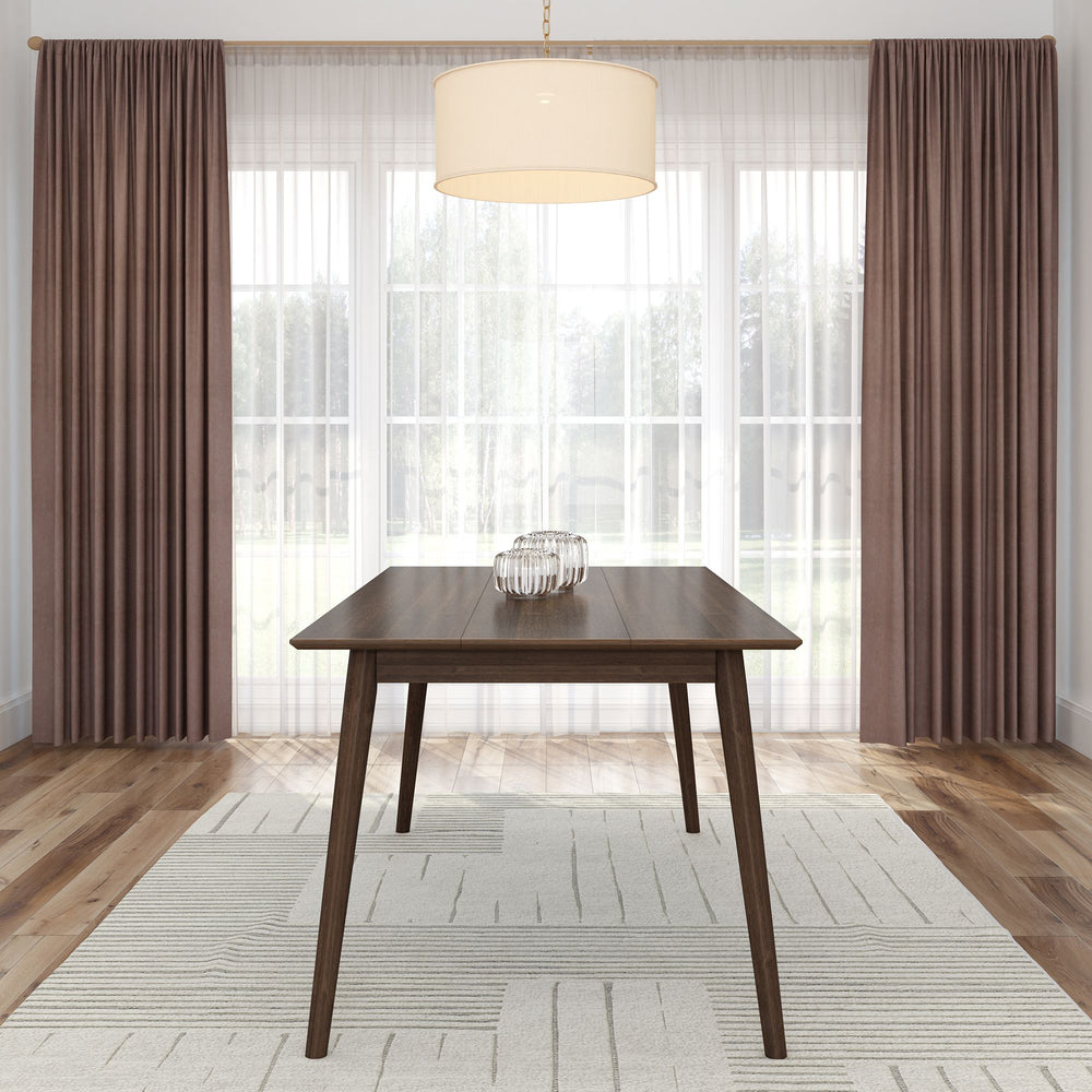 Modern dining room with a sleek wooden table on a patterned rug, large windows with sheer curtains, and a stylish pendant light.