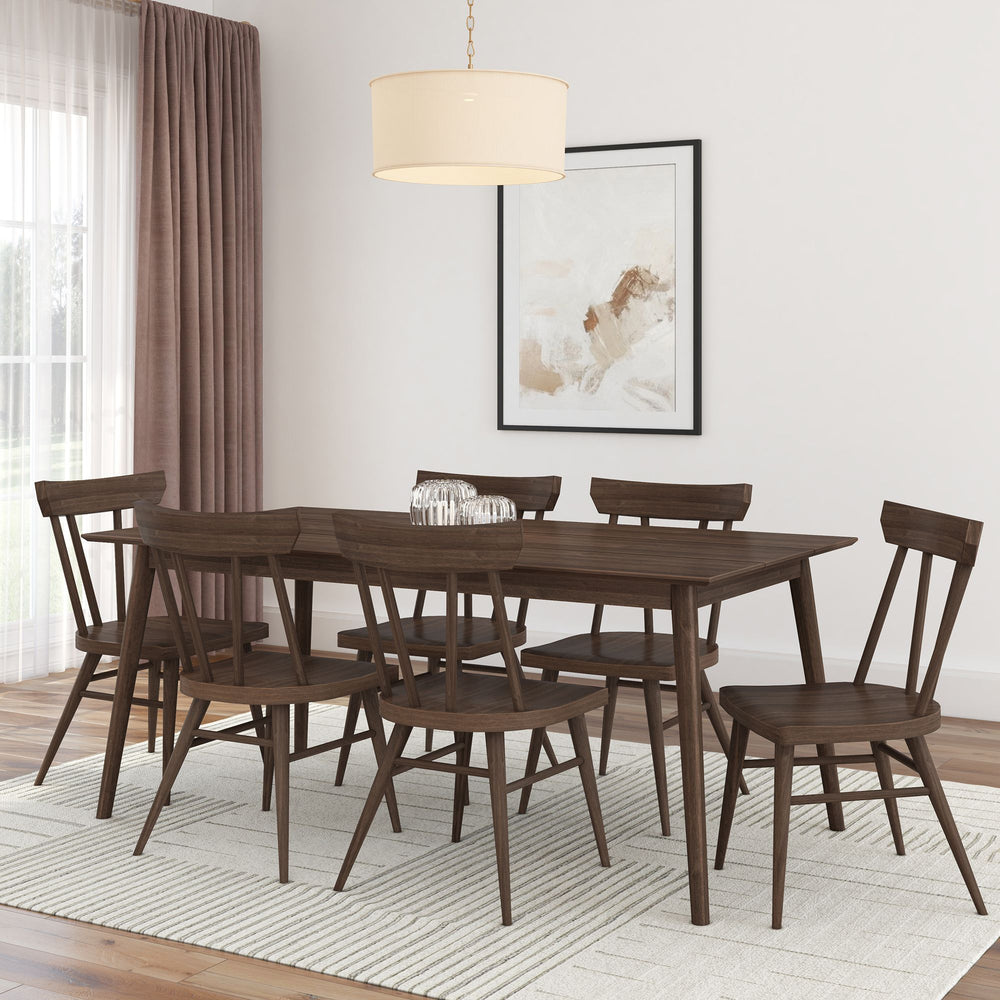 Modern dining room with wooden table and chairs on a light rug, featuring a pendant light and abstract wall art.