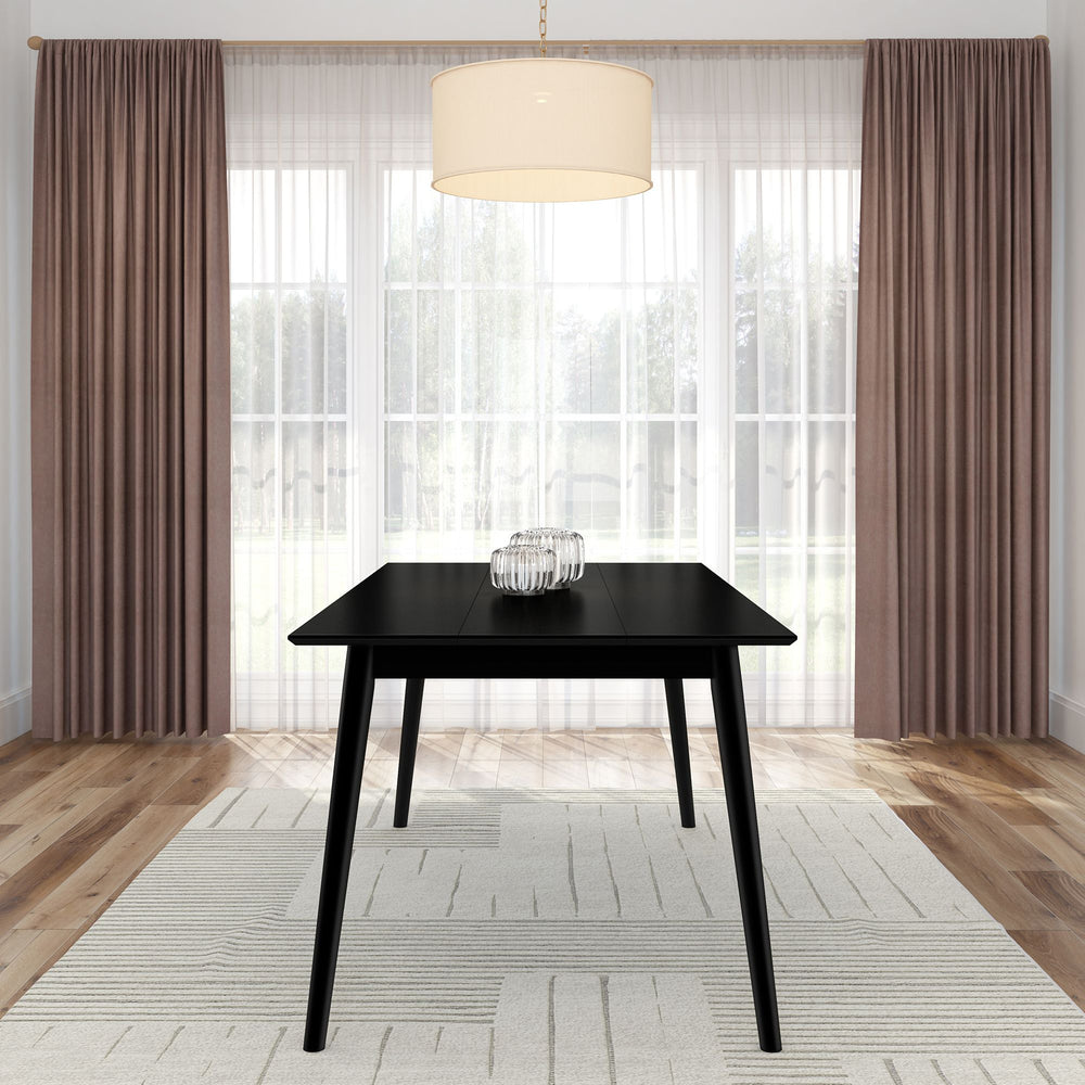 Modern black dining table in a bright room with elegant curtains and a pendant light.