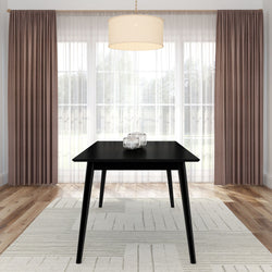 Modern black dining table in a bright room with elegant curtains and a pendant light.