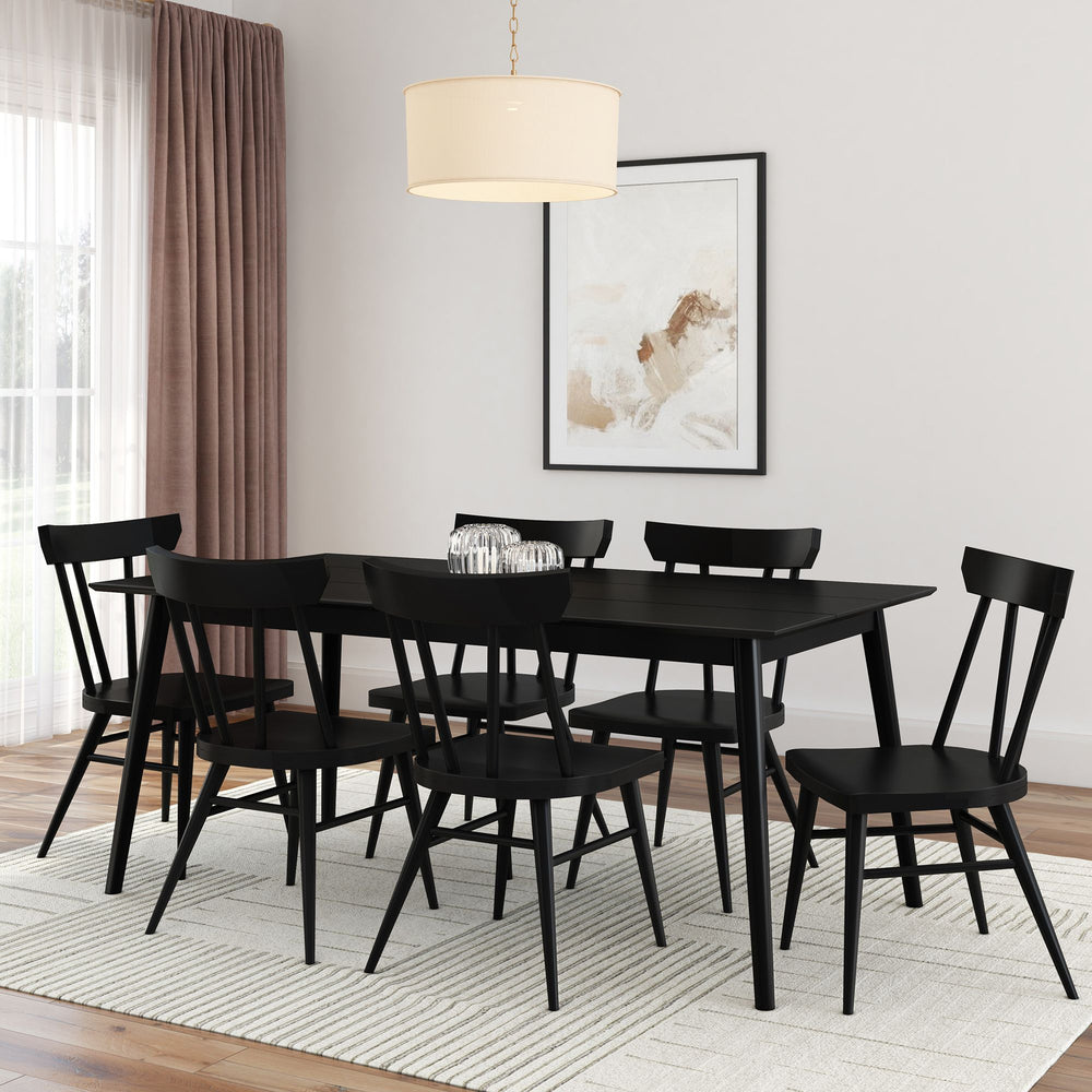 Black wooden dining table set with chairs in modern dining room.