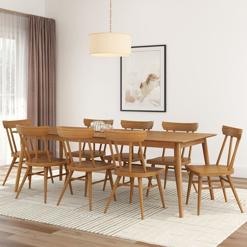 Mid-century modern dining room with wooden table and chairs on a textured rug, featuring minimalist wall art.