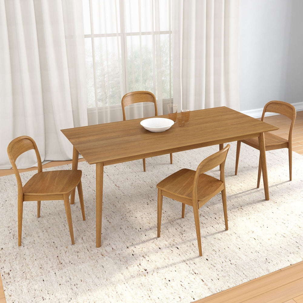 Modern wooden dining table set with four chairs on a light-colored rug in a bright dining room.