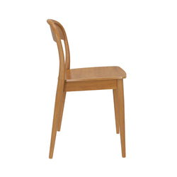 Side view of mid-century modern light oak wooden dining chair with curved backrest, solid wood seat and tapered legs on white background