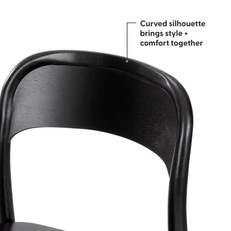 Close-up of a black curved wooden dining chair back with ergonomic silhouette and matte finish, modern bistro-style chair on white background