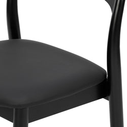 Close-up of modern black wooden dining chair with padded seat and curved backrest