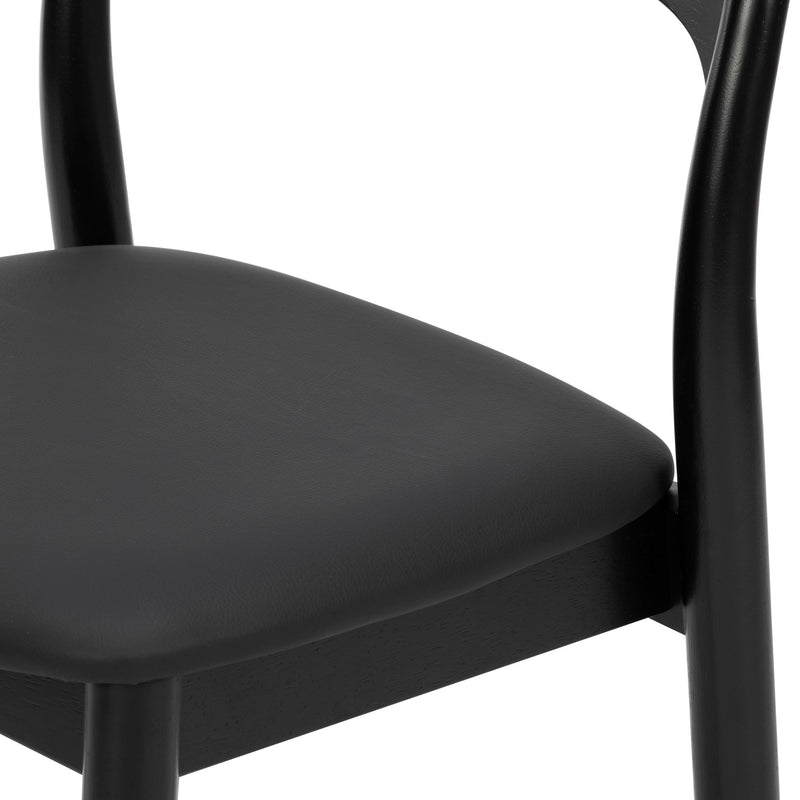 Close-up of modern black wooden dining chair with padded seat and curved backrest