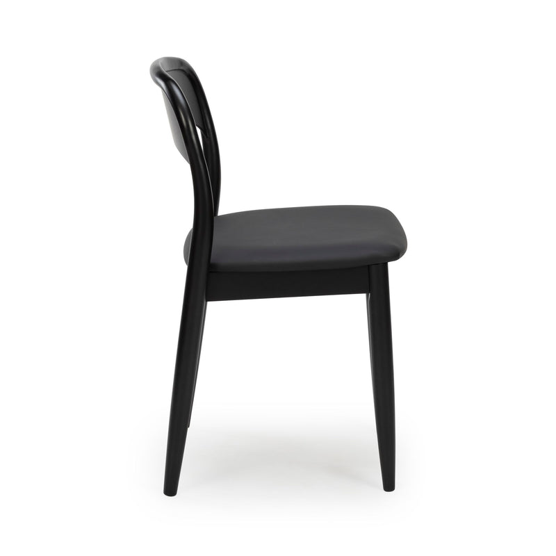 Side view of a black modern dining chair with curved backrest, padded seat and tapered legs, minimalist Scandinavian design