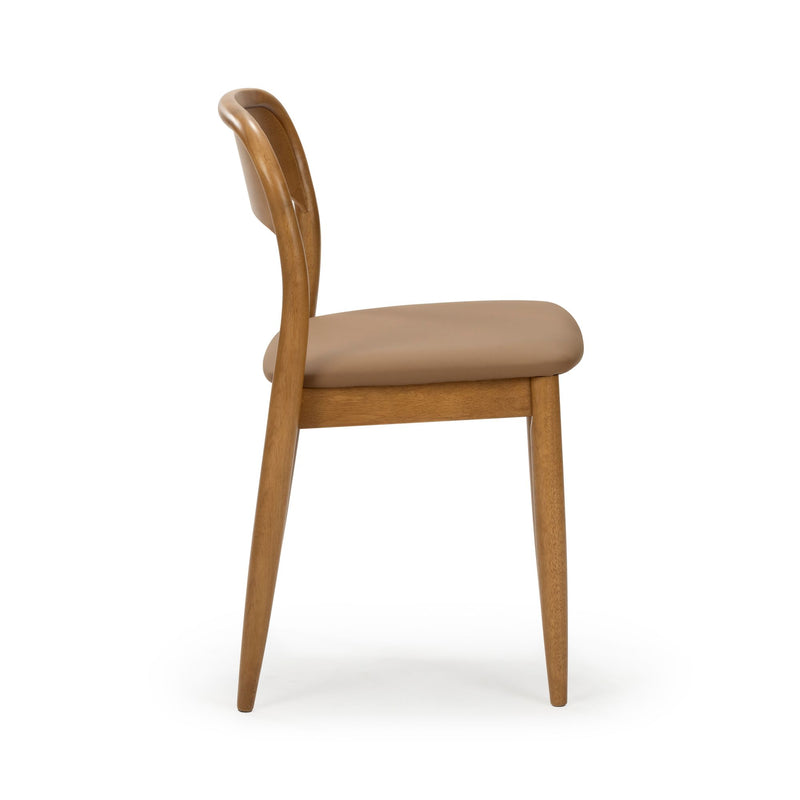 Side view of mid-century modern oak dining chair with curved backrest, tapered legs and tan leather-upholstered seat on white background