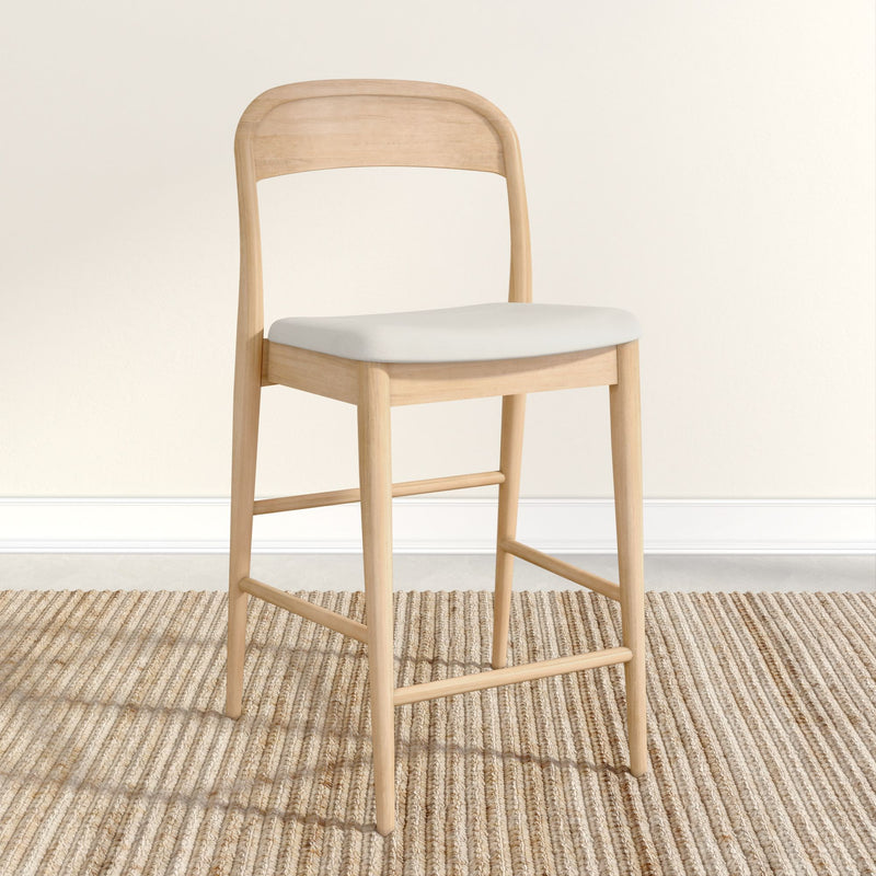 Natural wood bar stool with white cushion on a textured beige rug.