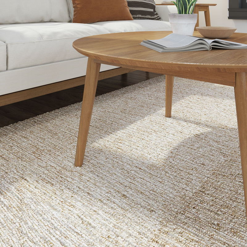 Modern living room with a wooden coffee table, beige textured rug, and cozy white sofa.