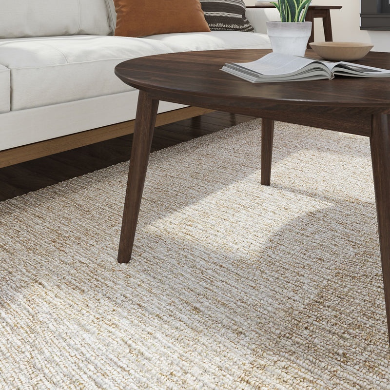 Modern living room with white couch, dark wooden coffee table, and textured beige rug.