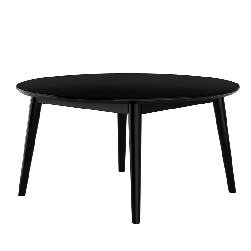 Modern round black dining table with four legs and sleek design.