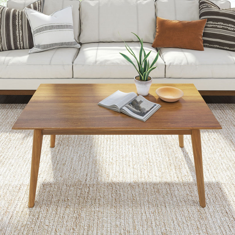 Modern wooden coffee table with decor in a stylish living room setting.