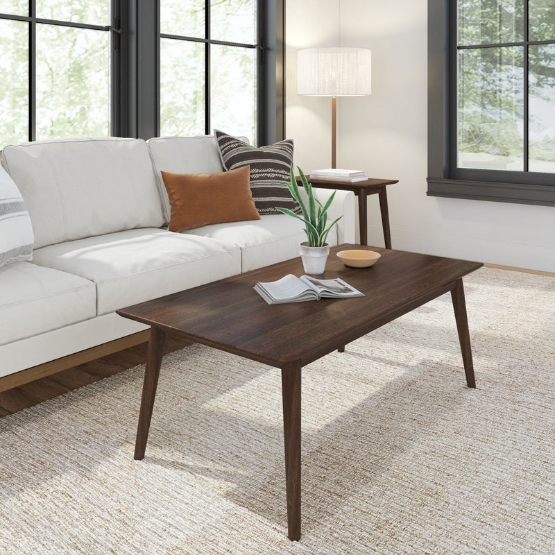 Modern living room with white sofa, wooden coffee table, and indoor plant.