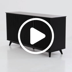 Black slatted media console sideboard with tapered mid-century legs — modern black TV cabinet for living room storage (video play icon overlay)
