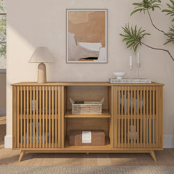 Modern wooden sideboard with slatted doors, styled with a lamp, artwork, books, and plants in a minimalist living room.