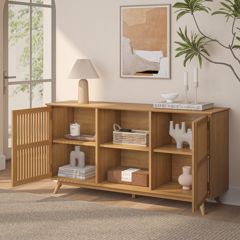 Modern wooden sideboard with decorative items, indoor plant, and framed abstract art in a stylish living room.