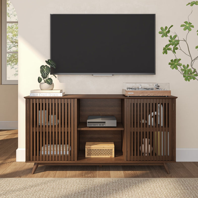 Mid-century modern media console with slatted wood design beneath wall-mounted flat-screen TV in stylish living room.