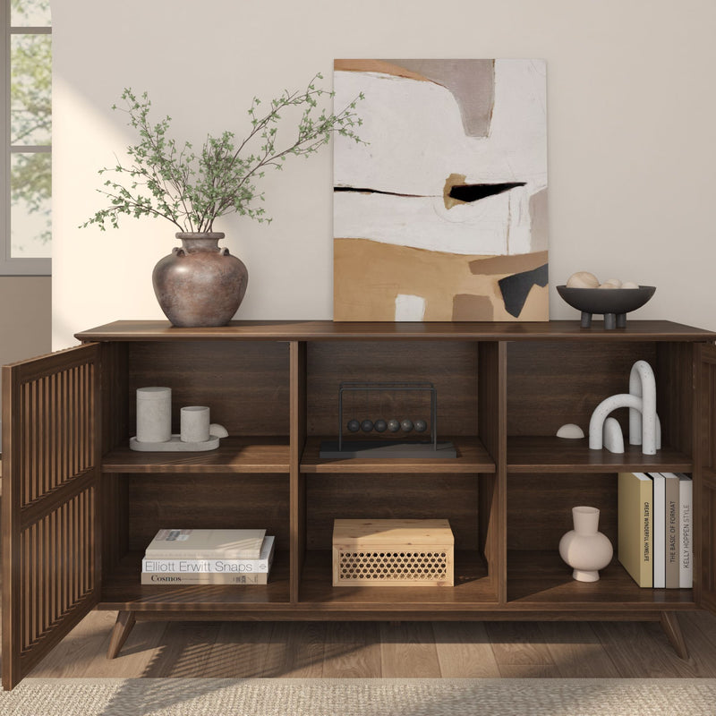 Modern wooden sideboard with decorative items, abstract art, and plant vase in a minimalist living room setting.