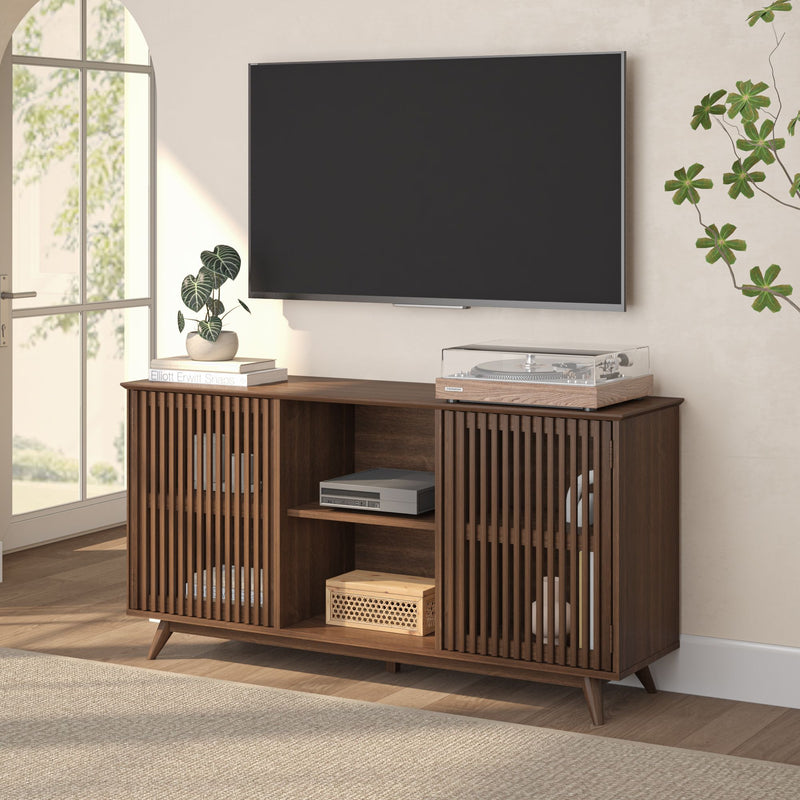 Mid-century modern walnut media console with slatted doors holding turntable, AV components and books under wall-mounted flat-screen TV in bright living room