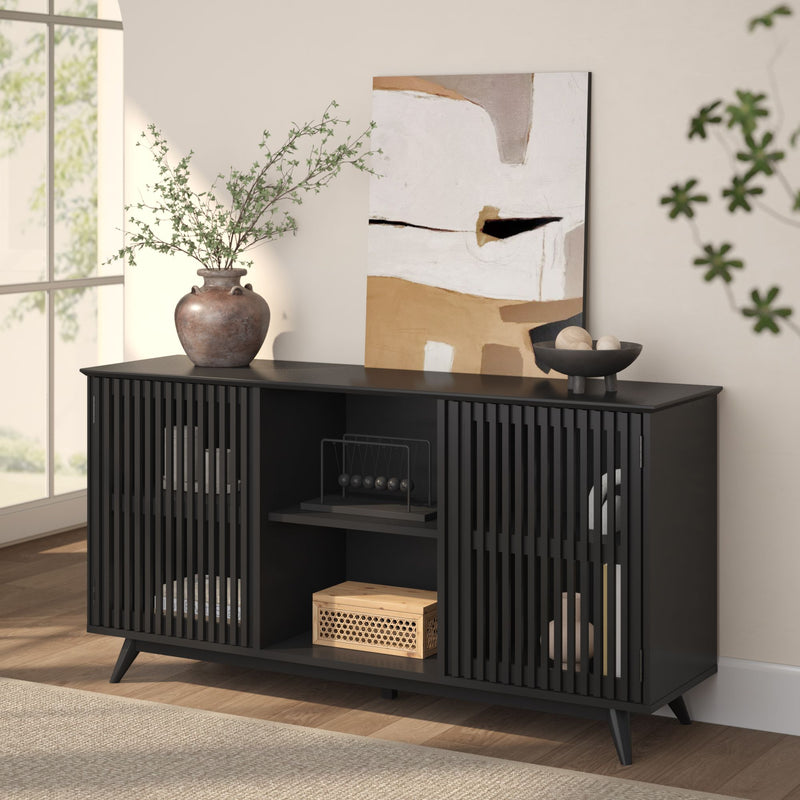 Black modern sideboard with slatted doors, decorative vases, abstract art, and natural light in a stylish living room.