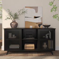 Modern black cabinet with abstract art and decorative vase in stylish living room setting.
