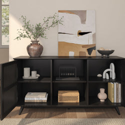 Modern black sideboard with decorative vases, abstract painting, and home decor items on styled shelves.