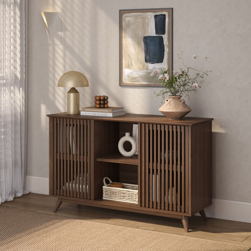 Mid-century modern wooden sideboard with decorative vase and lamp in stylish living room interior.