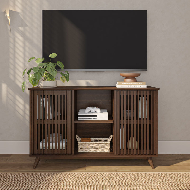 Mid-century modern TV stand with slatted doors and storage shelves, featuring a TV and decorative plants.