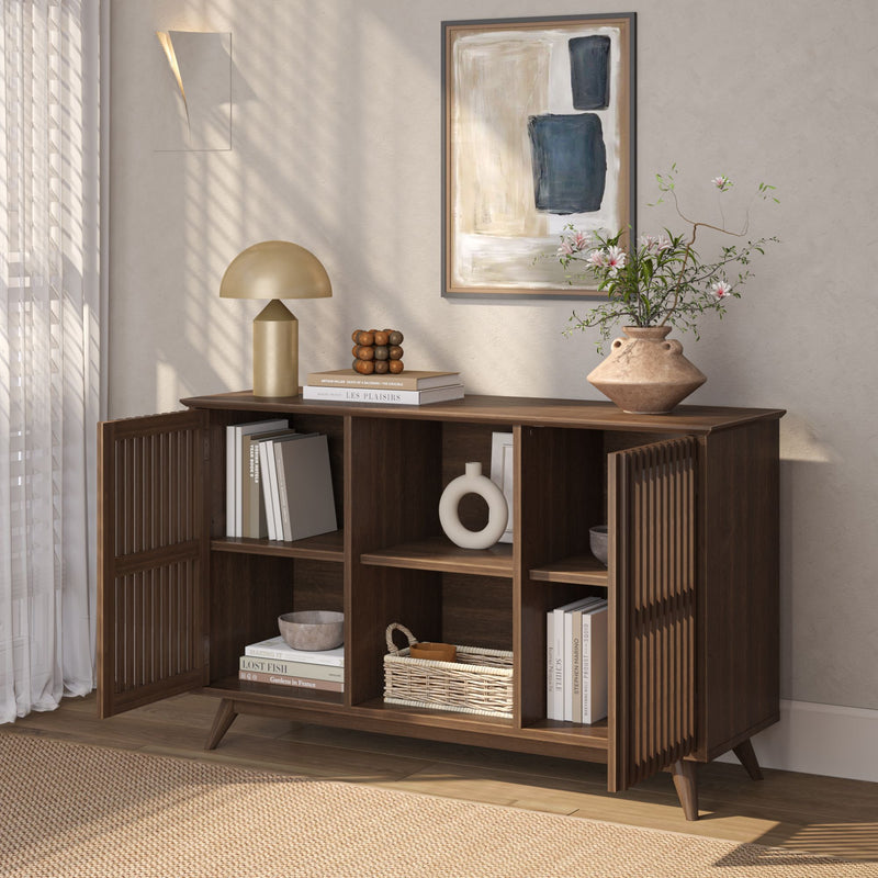Mid-century modern wooden sideboard with books, decor, and a lamp in a stylish living room setting.
